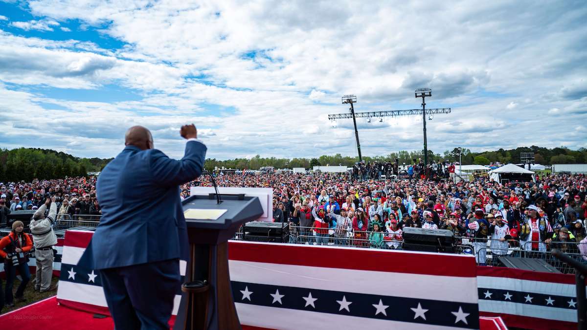 Mark Robinson for Governor North Carolina with fist up on stage in front of huge crowd